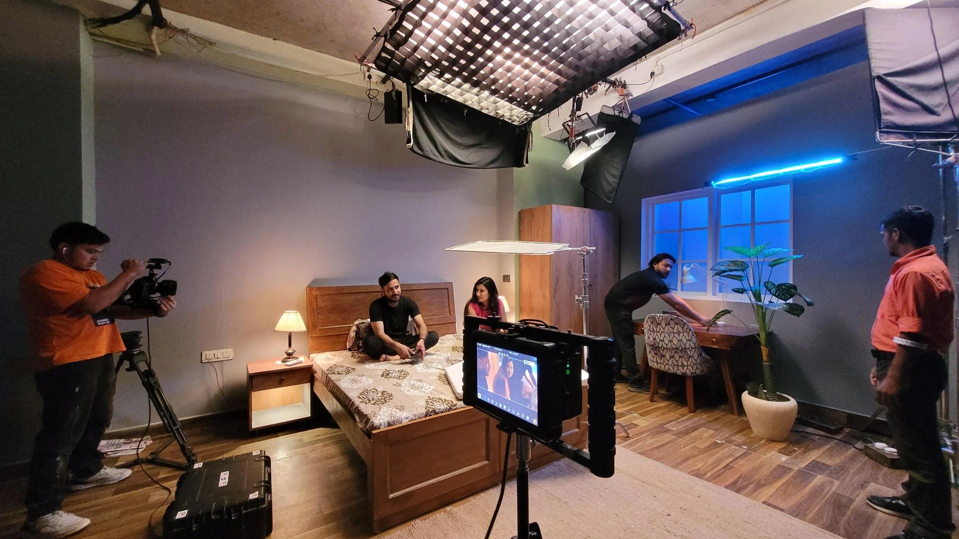 The Eknetra camera crew on a bedroom set